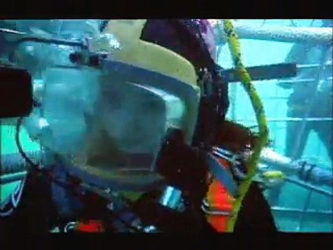 Amy goes scuba diving in a shark cage