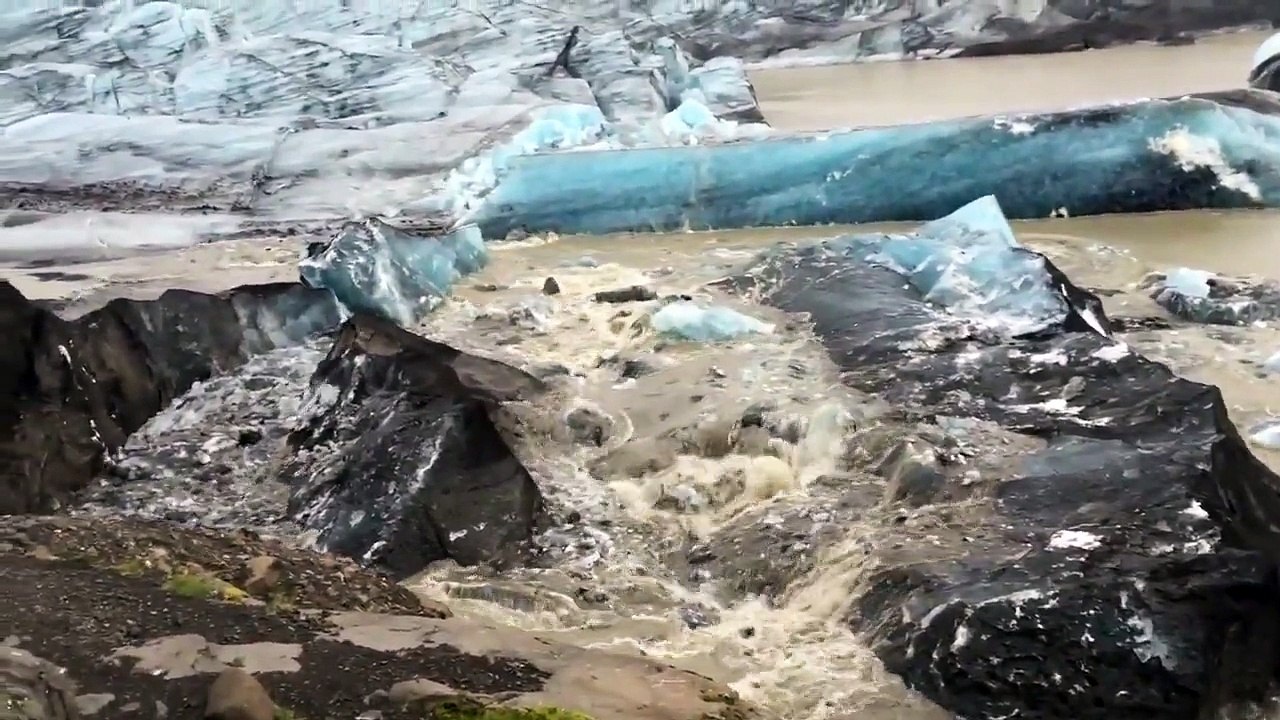 Iceberg Covered with Volcanic Ash Breaking Off from Svinafellsjokull Glacier in Iceland - AMAZING!