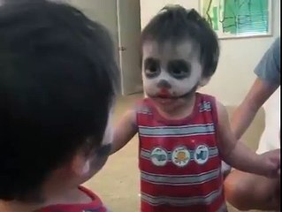 funny baby scares himself in mirror