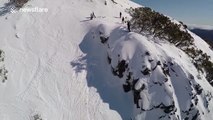 Man attempts switch 180 on skis... fails!