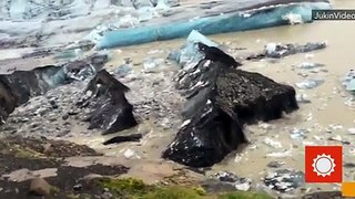 WOW- Iceberg Covered With Volcano Ash Breaks Off Glacier in Iceland