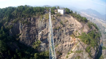More than 100 people perform yoga on China's see-through bridge