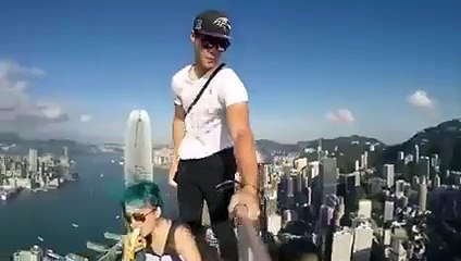 Couple Taking Selfie on the top of Tall buliding