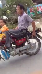 2 YO kid driving a motorcycle... Insane
