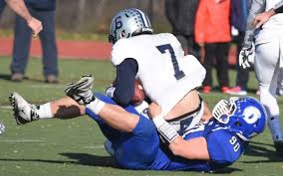 Dwight Freeney congratulates Mark Evanchick for breaking the all-time record with 62.5 high school career sacks.