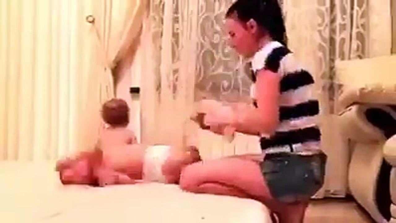 Mummy clothing her two babies at the same time by entertainment world