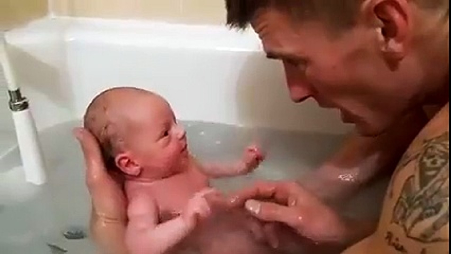 New born baby taking bath with his Father