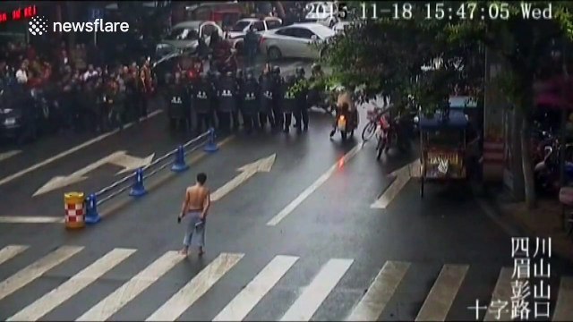 Topless man armed with knives confronts riot police... Error!