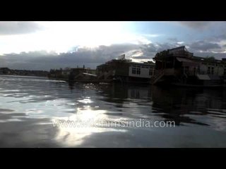 House boats on the Dal: reflections of a cloudy sky with a rainbow
