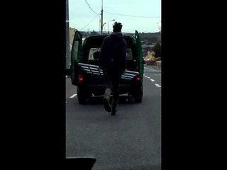 Man Runs Behind Moving Van to Keep Gate Inside