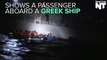 Passenger On A Greek Ship Tries To Deflate A Rubber Boat Carrying Refugees