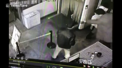 Man climbs into security scanner on conveyor belt at train station