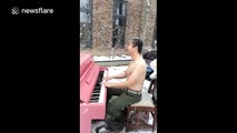 Half-naked man plays piano and sings in the snow