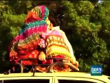 Brave Women of Karachi Traveling Over The Roof of a Taxi on Shaare Faisal