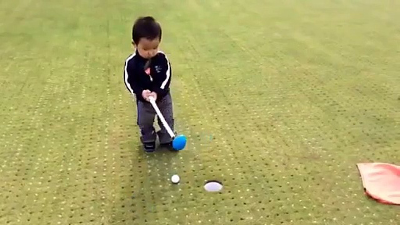 fuuny child playing golf