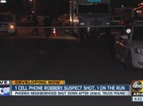 Armed robbery suspect shot by police; second suspect on the run
