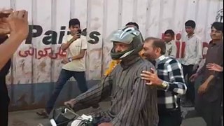 MQM leader Farooq Sattar take to the streets of Karachi on motorbikes