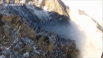 Winter paragliding flight above clouds in Carpathian Mountains