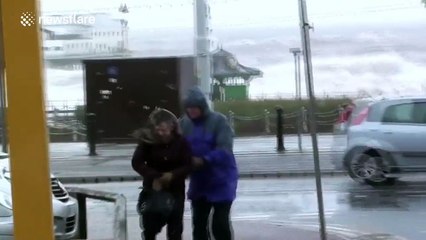 Elderly man and woman battle against strong Storm Clodagh winds