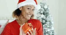 Smiling Attractive Woman Holding a Christmas Gift | Stock Footage - Videohive