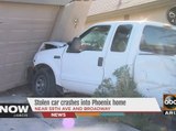Stolen car crashes into Phoenix house