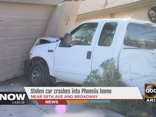 Stolen car crashes into Phoenix house
