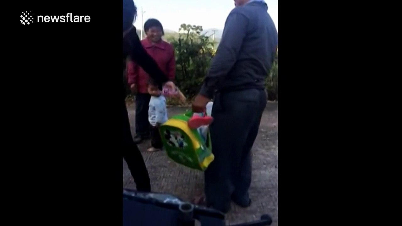 Granddad carries granddaughter in a sack to school bus stop