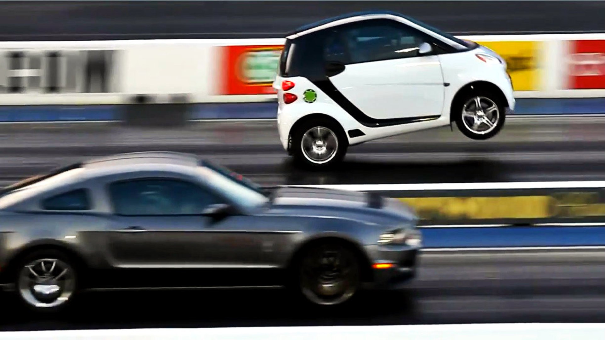 ⁣Smart Car Pops a Wheelie and Smokes Mustang Off The Line