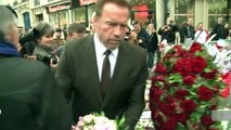 Arnold Schwarzenegger lays flowers at Paris Bataclan