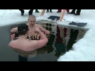 Russian ice swimmers play chess in frozen lake