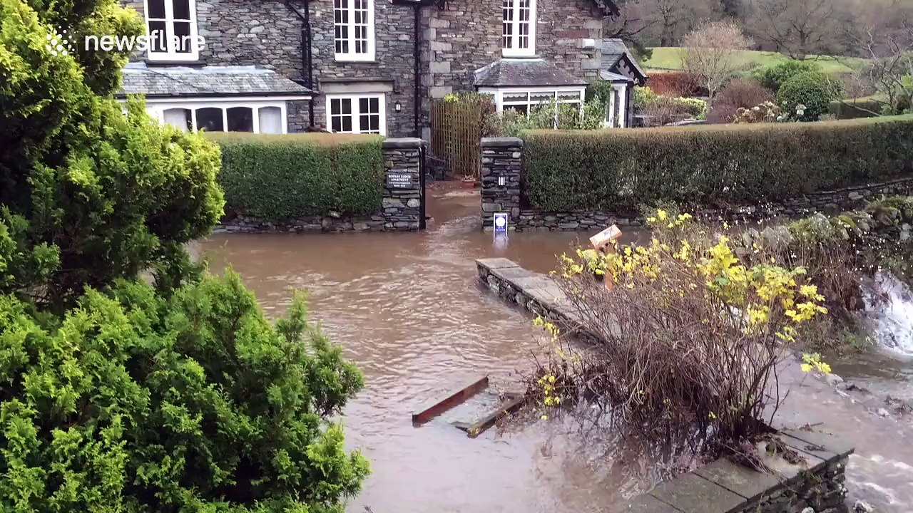 Flood water runs into the River Rothay after Storm Desmond