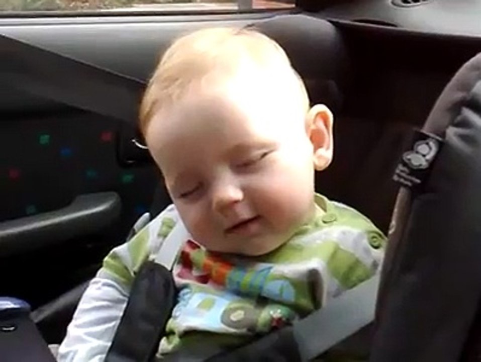 cute expression by little kid during half sleep .