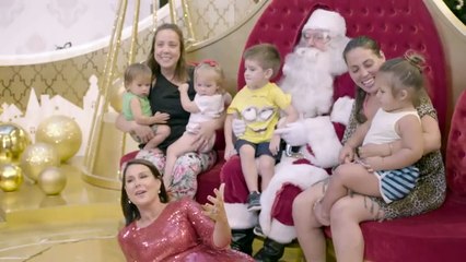 Julia Morris gets into the festive spirit and cuddles up to Santa