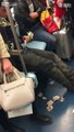 Beggar counts his cash on the train