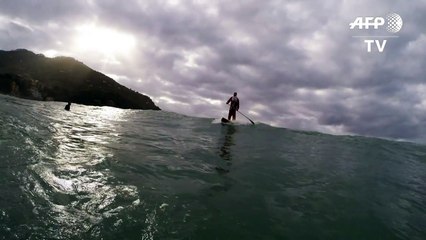 Slow-mo Santa swaps sleigh for surf to ride Italian waves
