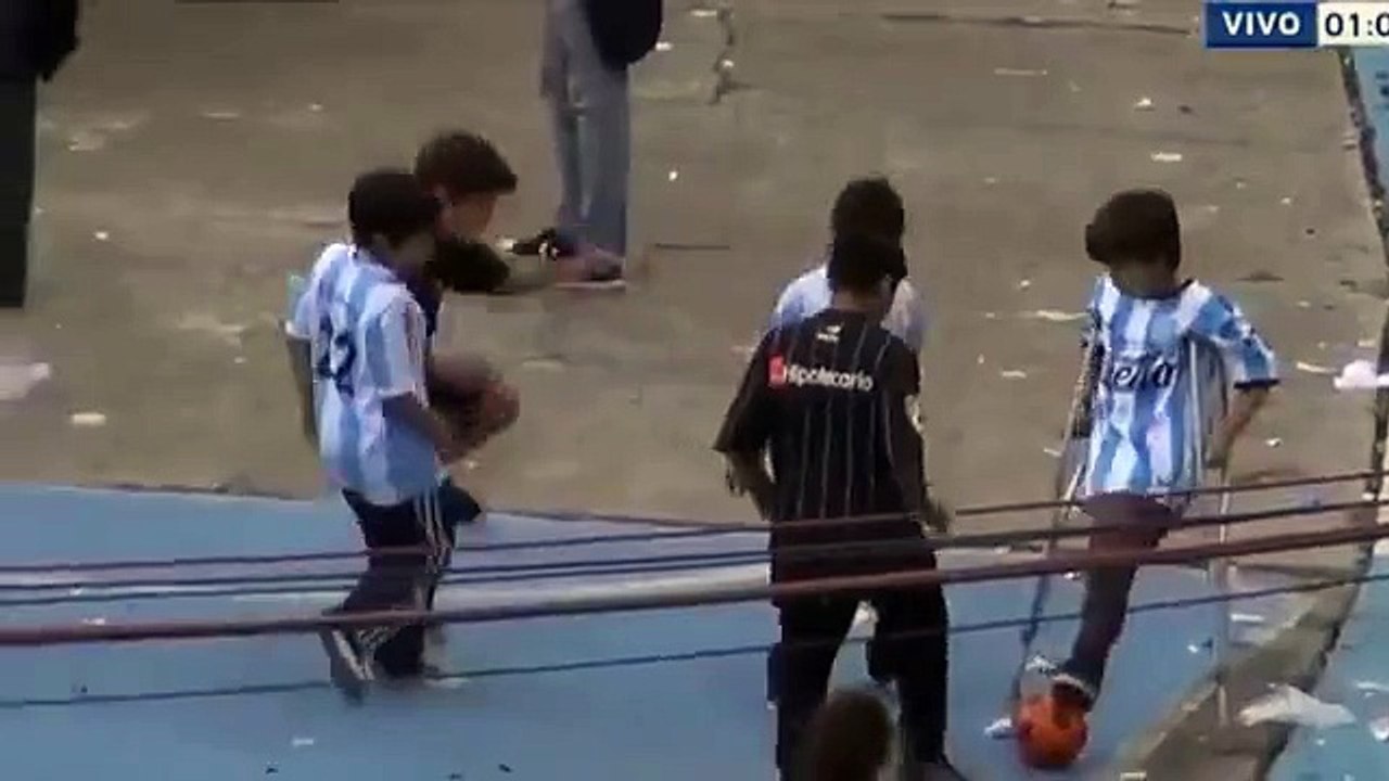 Boy without a leg playing football with other boys during the match Racing Club v Independiente 2015