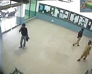 Pakistani goes through glass door