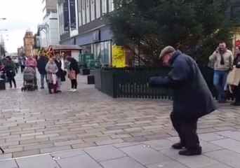 Elderly Man Dances With Christmas Spirit in Middlesbrough