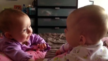 Twin babies talk and hold hands for the first time