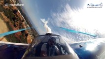 Aerobatic pilot turns plane upside down very close to the ground