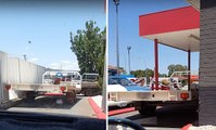 Bizarre moment a man squeezes his trailer into the drive-through