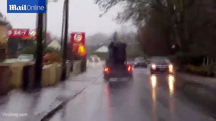 A person trying to move a sofa in the midst of Storm Desmond