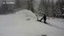 Man ploughs through deep snow in Canada