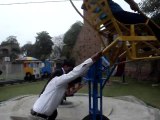 College boys having fun in the park by having a lad on the dangerous chair - funny video