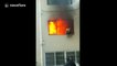 Firefighter escapes by jumping off building after his suit catches fire
