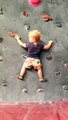 19 month old child climbing an indoor rock wall