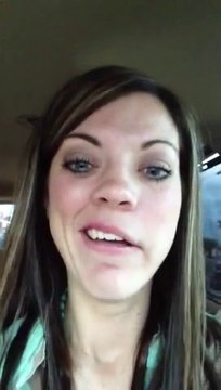 Woman laughs at her numb face after leaving the dentist