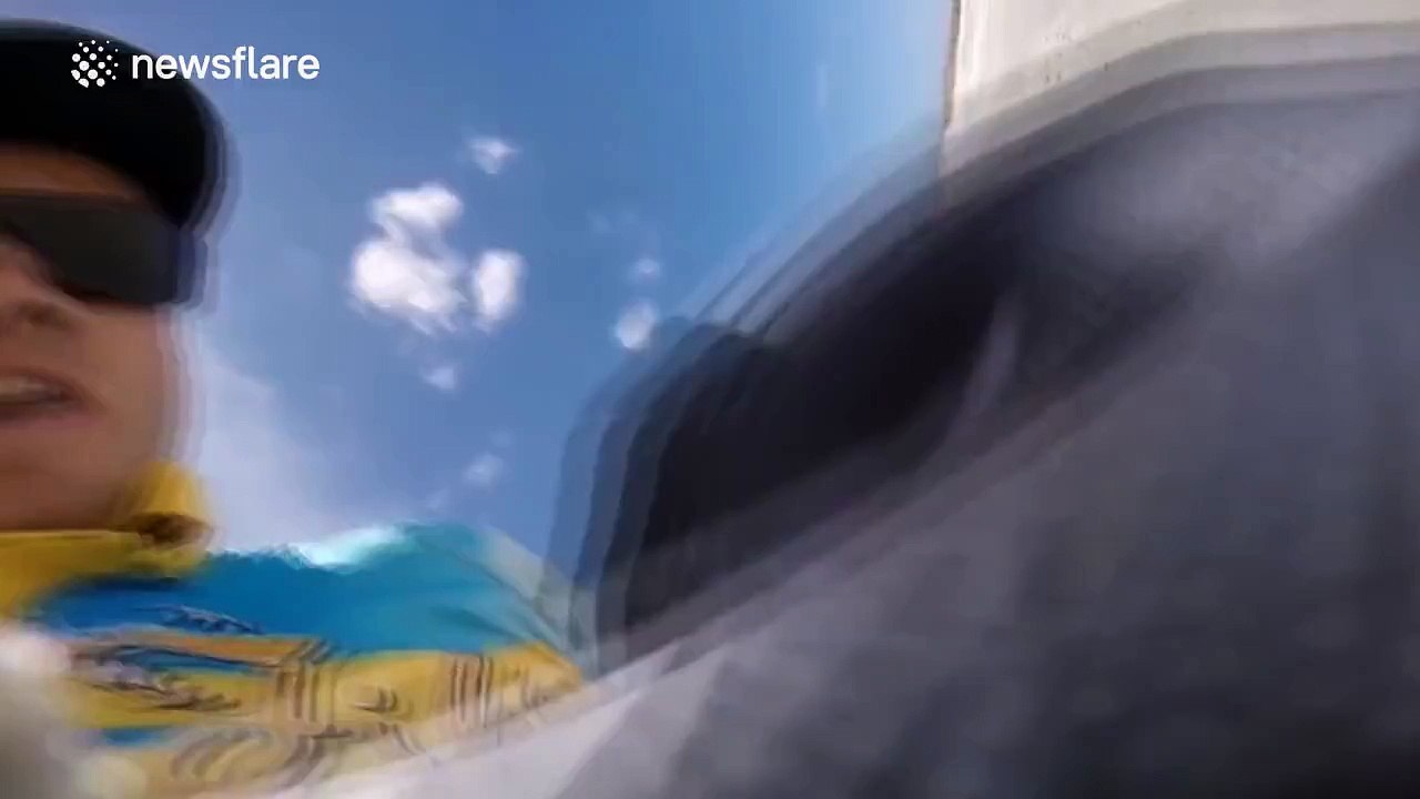 Moment fisherman gets hit in the face by caught shark