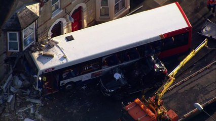 Seven hospitalised after bus crashes into building