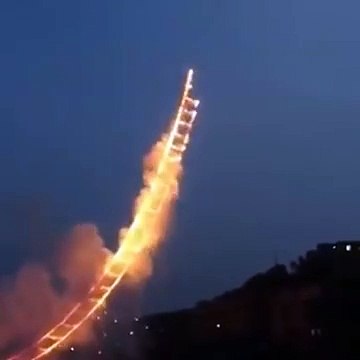 Sky Ladder: a pyrotechnic artwork in the shape of a 500 meter ladder by Cai Guo-Qiang